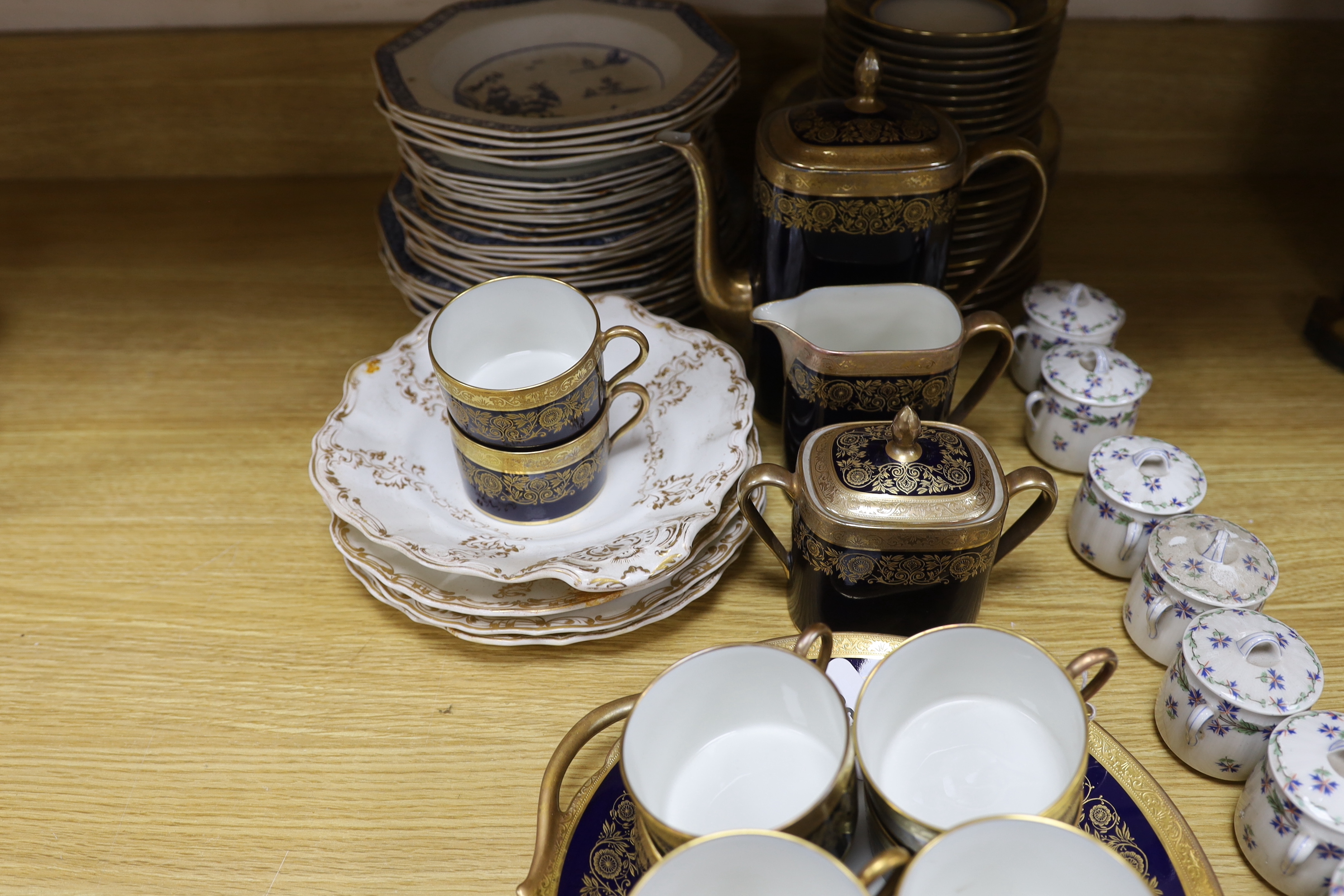 A Raynaud and Co. Limoges gilt and navy ten cup coffee service, a Woodsware part dinner service and eight Limoges floral pots and covers